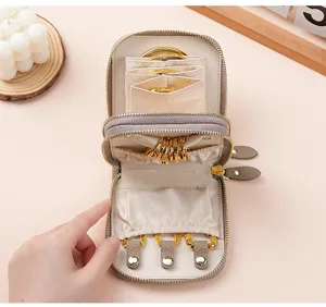 Detailed interior view of a premium leather double-zipper jewelry storage pouch with gold rings