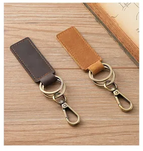 Detailed macro view of handmade crazy horse leather keychains with vintage brass hardware