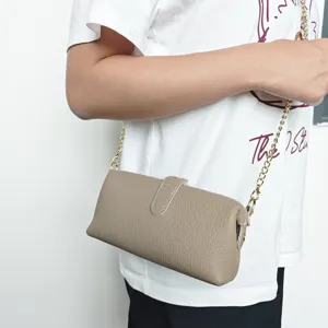 Elegant taupe genuine leather crossbody bag featuring a detachable gold chain strap