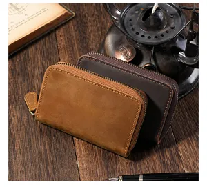 Detailed macro view of vintage Crazy Horse leather key pouches with antique bronze zipper