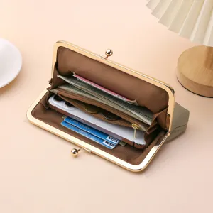 Elegant women's genuine leather kiss-lock clutch bag showing large interior capacity