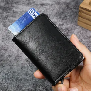 Sleek black RFID blocking pop-up card holder held in hand showing credit cards
