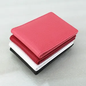 Stack of four textured leather driver's license covers in pink, red, white and black