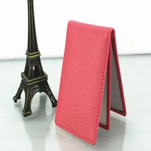 Side profile view of the pink pebbled leather driver license cover in a travel setting
