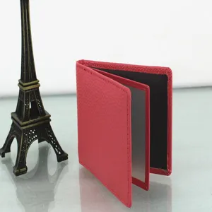Detail of red pebbled leather driver's license holder with clear ID window slots.
