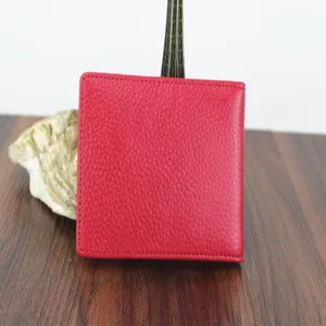 Close-up of the pebbled leather texture and red stitching on the driving license holder