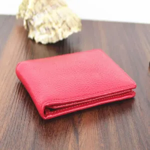 Premium red genuine leather driver's license holder with elegant pebbled texture on wood