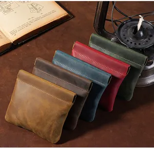 Close-up of Crazy Horse leather coin purses in various colors showing fine texture.