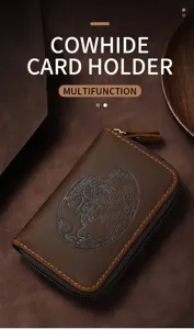 Detailed macro view of the embossed dragon pattern on the brown cowhide card holder