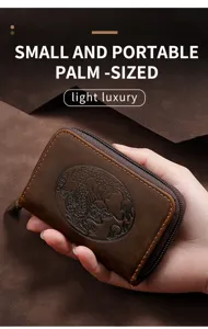 Close-up of a palm-sized brown leather card wallet with an embossed dragon design