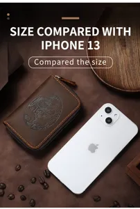 Vintage brown leather card holder size comparison with a white iPhone 13 smartphone