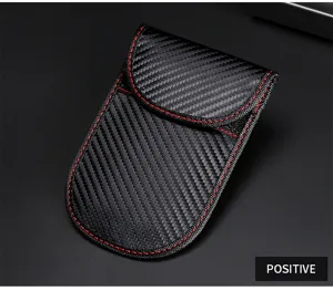 Close-up of carbon fiber pattern car key bag with red stitching