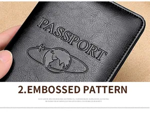Detailed macro shot of black leather passport cover showing embossed globe and text pattern