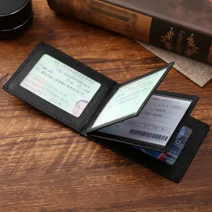 Classic black leather driver's license and ID card holder shown open on a wooden table