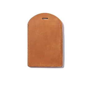 Detailed view of a vintage tan crazy horse leather luggage tag with precision stitching