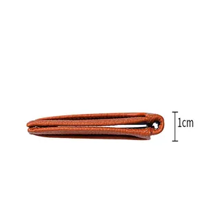 Side view detail showing the 1cm thickness of this ultra-thin brown leather card holder