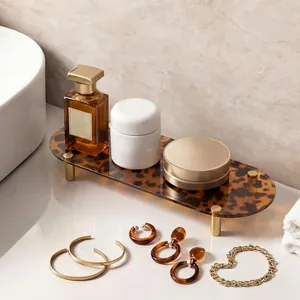 Detail view of a vintage leopard print acrylic tray with gold metal legs for luxury vanity storage