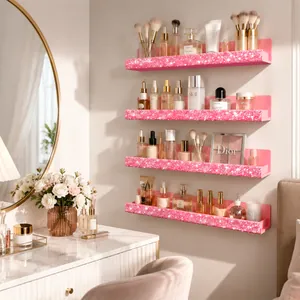 Close-up of four pink glittery acrylic wall shelves organizing various cosmetic bottles.