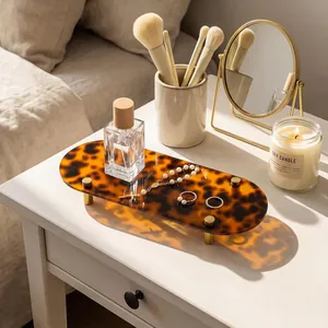 Macro view of vintage tortoiseshell acrylic tray showing tortoiseshell pattern and gold legs