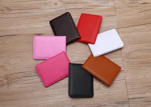 A collection of colorful slim pebbled leather driving license holders on a wooden background