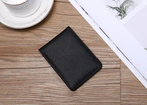 Close-up of minimalist black pebbled leather ID and driver's license holder