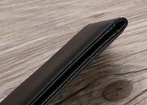 Close-up of the ultra-thin edge and textured finish of a black driver's license holder.