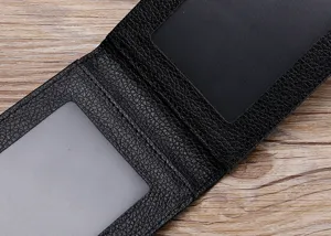 Detail view of a black leather driver license holder showing dual transparent card slots