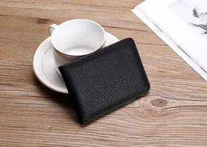 Detail view of a black lychee-textured leather driver's license cover on a desk