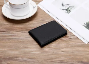 Slim black pebbled leather texture driver's license holder on wooden table