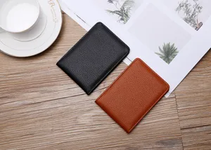 Detailed view of slim black and brown pebbled leather document holders on a desk