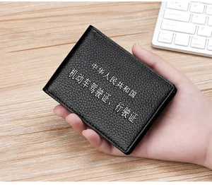 Close-up of black lychee pattern leather driver's license and vehicle registration holder