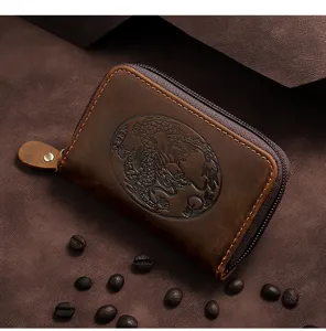 Detail of premium brown leather card holder featuring traditional embossed dragon design.