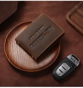 Close-up of vintage brown crazy horse leather driver's license cover with embossed text