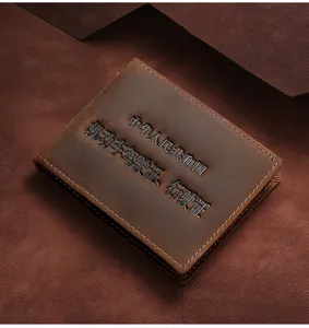 Close-up of vintage brown crazy horse leather driver's license holder with embossed text