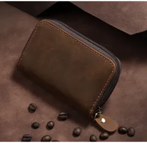 Close-up view of vintage brown crazy horse leather card holder with a sturdy metal zipper