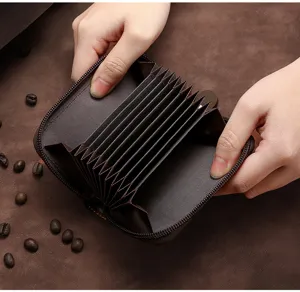 Close-up of brown accordion-style card holder showing multiple interior slots for cards
