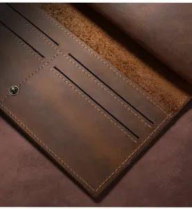 Close-up detail of vintage crazy horse leather long wallet showcasing card slots and stitching.