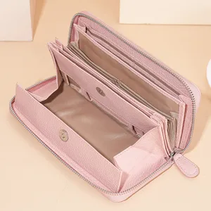 Pink leather long wallet for women with multiple card slots and zip around closure design.