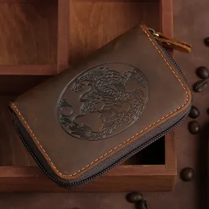 Vintage brown leather card holder featuring a detailed embossed dragon design and zipper.