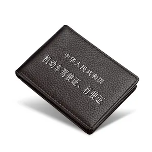Dark brown leather driver's license holder with litchi grain texture and printed text