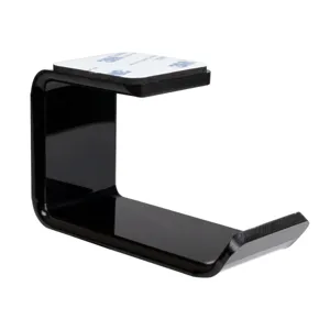 Close-up of black acrylic L-shaped under-desk headphone hanger with adhesive tape