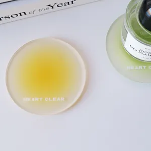Detailed macro shot of a yellow frosted acrylic coaster with Heart Clear text engraving