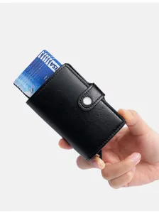 Detail shot of a black automatic pop-up card holder with PU leather and button closure