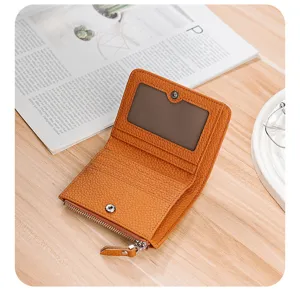 Macro view of interior of a small orange leather wallet with card slots and ID window