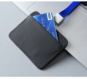 Macro view of a premium black leather ID card holder with stitched edges and lanyard.