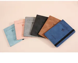 Closeup of multi-color travel passport holders with elastic band and card slots.