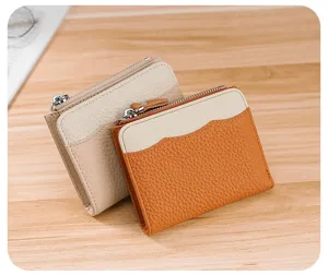 Close-up of small genuine leather coin purses with pebbled texture and zipper closure