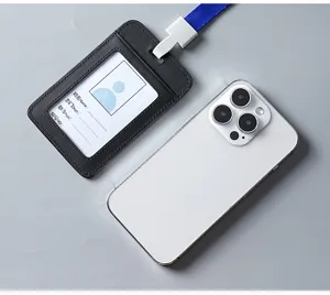Detailed view of a black leather ID card holder with a blue lanyard next to a phone