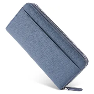 Close-up detail of blue genuine leather long wallet, featuring card slots and smooth zipper.