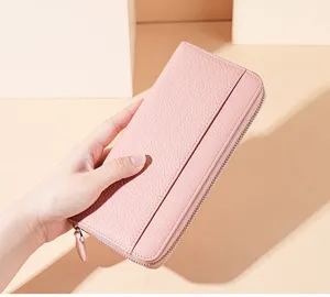 Pink leather long wallet detail view, featuring zipper closure and multi-card capacity.